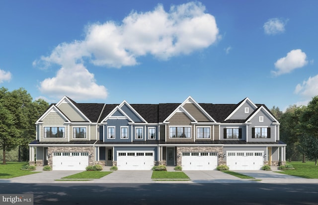 townhome / multi-family property with driveway and stone siding