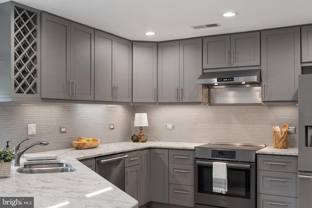 3 Spa Creek Lndg Unit A, Annapolis, MD 21403 - kitchen with stainless steel appliances, a sink, gray cabinetry, range hood, and light stone counters