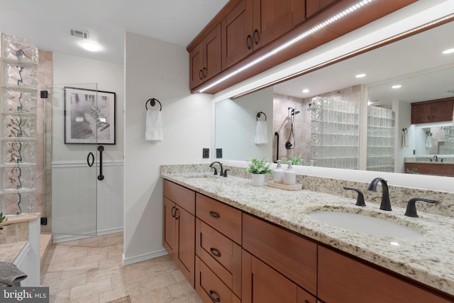 3 Spa Creek Lndg Unit A, Annapolis, MD 21403 - bathroom featuring a stall shower, double vanity, baseboards, and stone finish flooring