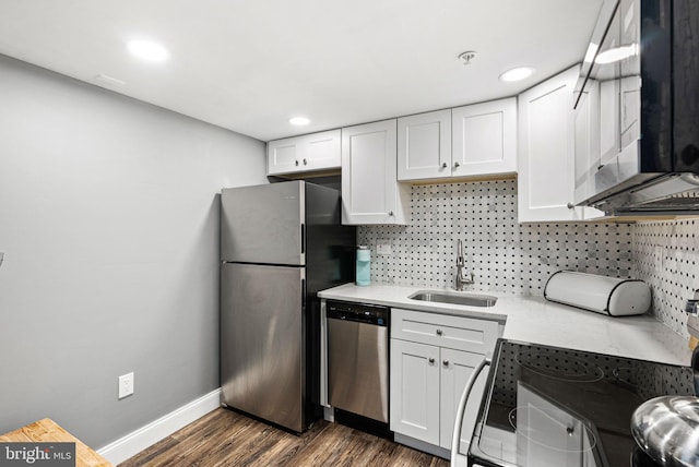 kitchen with a sink, stainless steel appliances, backsplash, light countertops, and white cabinets