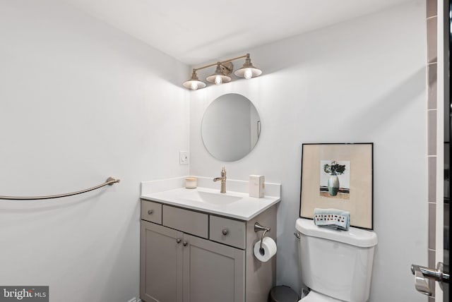 bathroom with toilet and vanity