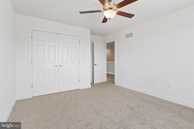 unfurnished bedroom featuring baseboards, carpet flooring, and visible vents