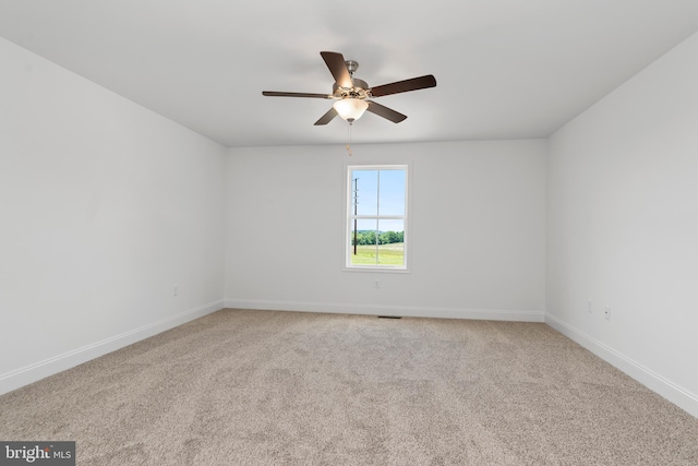 empty room featuring carpet flooring, ceiling fan, and baseboards