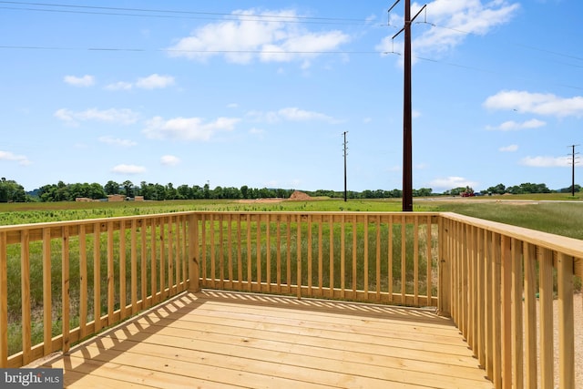 wooden deck featuring a rural view