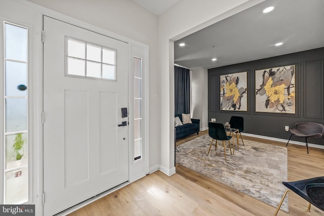 entrance foyer with wood finished floors, recessed lighting, and baseboards