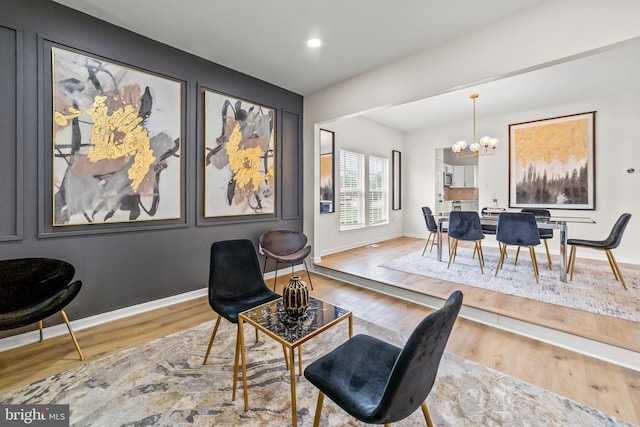 interior space featuring wood finished floors, recessed lighting, a notable chandelier, and baseboards