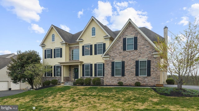 view of front of property featuring stone siding, stucco siding, a front yard, and a chimney