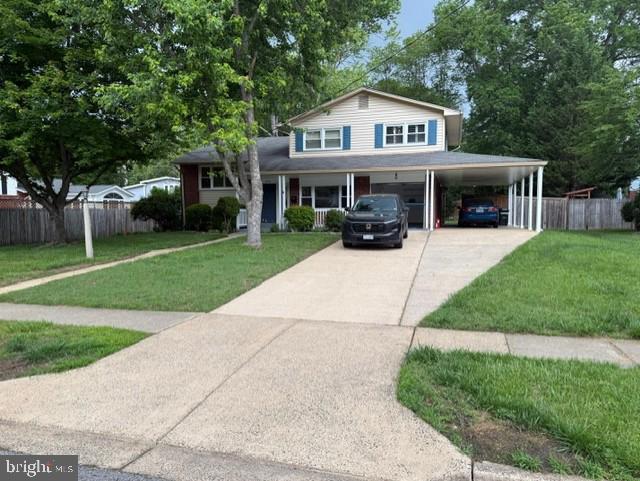 8916 Battery Rd, Alexandria, VA 22308 - view of front facade with concrete driveway, a carport, and covered porch