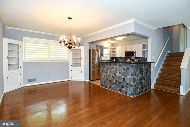8916 Battery Rd, Alexandria, VA 22308 - kitchen with appliances with stainless steel finishes, a chandelier, dark countertops, wood finished floors, and white cabinetry