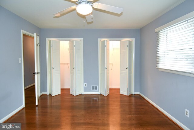 8916 Battery Rd, Alexandria, VA 22308 - unfurnished bedroom with wood finished floors, baseboards, a closet, a walk in closet, and ceiling fan