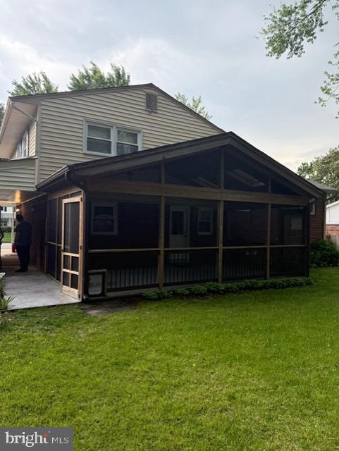 8916 Battery Rd, Alexandria, VA 22308 - rear view of property with a sunroom and a yard