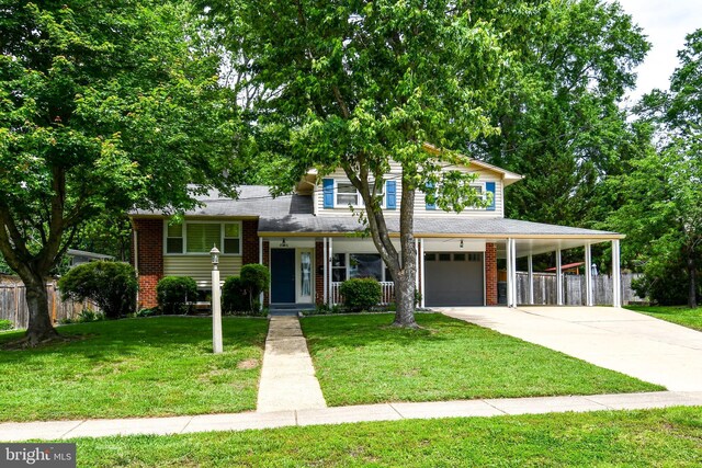 8916 Battery Rd, Alexandria, VA 22308 - split level home featuring a garage, a carport, concrete driveway, brick siding, and covered porch
