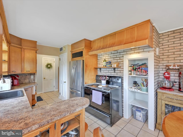 24 Keeler Ave, Stevens, PA 17578 - kitchen featuring electric range, freestanding refrigerator, light tile patterned floors, decorative backsplash, and light countertops