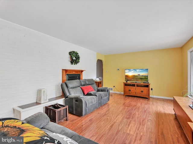 24 Keeler Ave, Stevens, PA 17578 - living area featuring light wood-style floors, arched walkways, and a fireplace