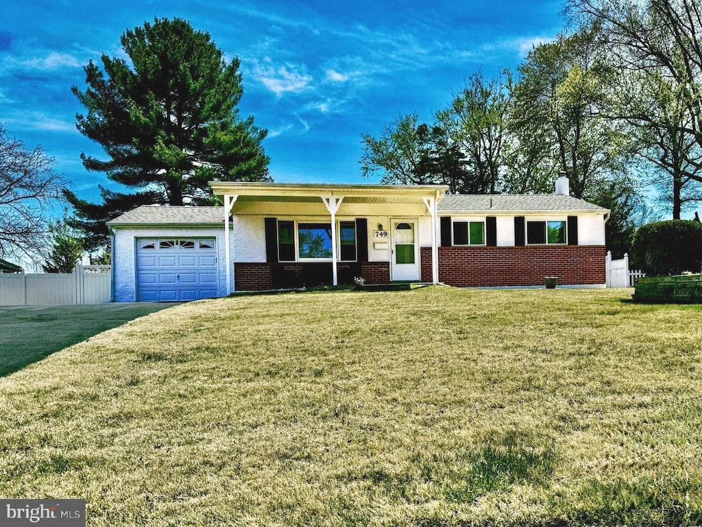 749 Ivers Ln, Warminster, PA 18974 - ranch-style home featuring a chimney, fence, a front lawn, an attached garage, and brick siding