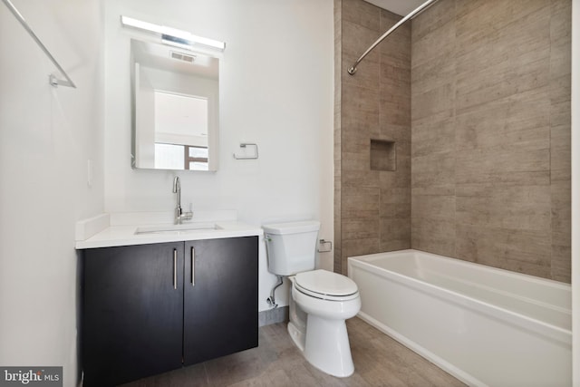 bathroom with toilet, wood finished floors,  shower combination, and vanity