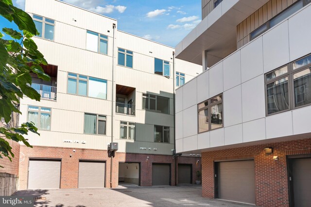 view of apartment building / complex featuring a garage