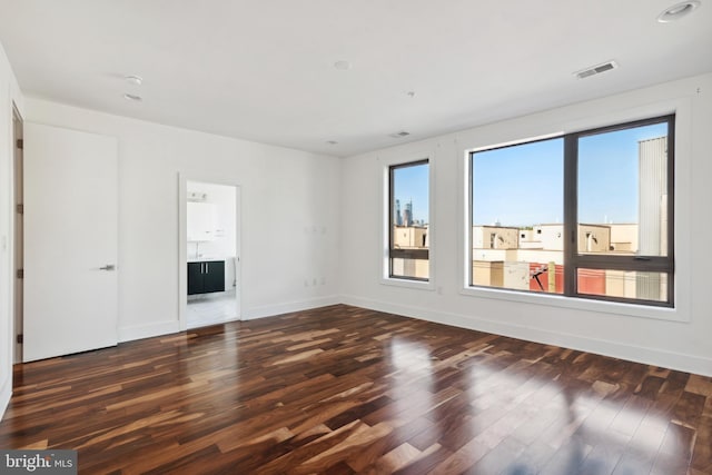 unfurnished living room featuring wood finished floors, baseboards, and recessed lighting
