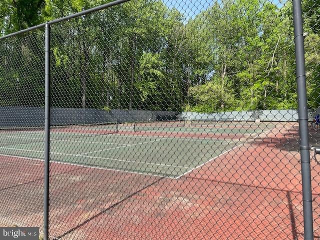 view of sport court featuring fence