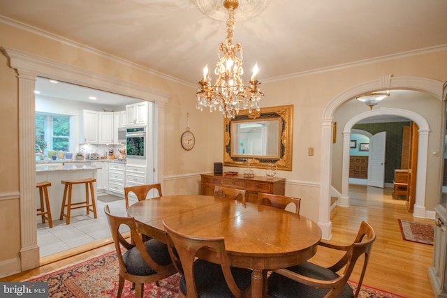 1511 Camden Ave, Salisbury, MD 21801 - dining space featuring arched walkways, light wood-style floors, crown molding, and a chandelier