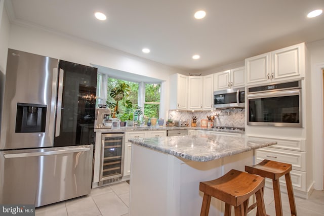 1511 Camden Ave, Salisbury, MD 21801 - kitchen featuring appliances with stainless steel finishes, wine cooler, light tile patterned floors, white cabinets, and recessed lighting
