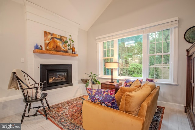 1511 Camden Ave, Salisbury, MD 21801 - living room with lofted ceiling, a glass covered fireplace, wood finished floors, and baseboards