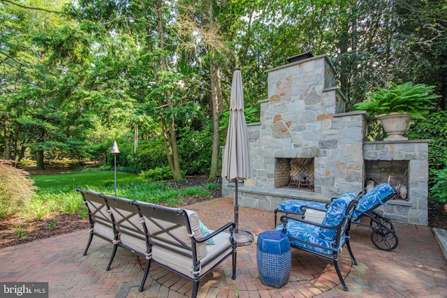 1511 Camden Ave, Salisbury, MD 21801 - view of patio featuring an outdoor stone fireplace and view of wooded area
