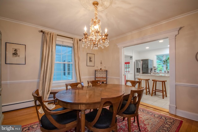 1511 Camden Ave, Salisbury, MD 21801 - dining room featuring a chandelier, light wood-type flooring, crown molding, and a baseboard radiator