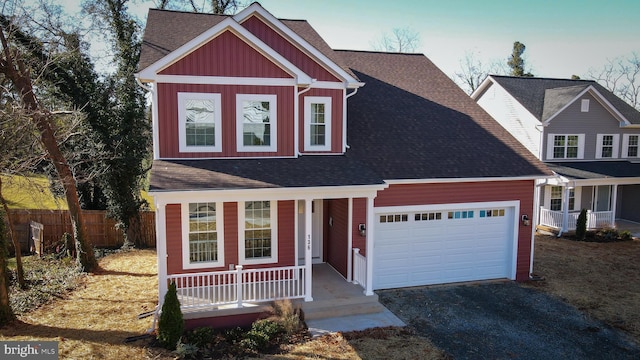 view of front of property with a garage, fence, board and batten siding, a porch, and driveway