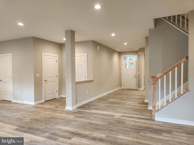 entryway featuring baseboards, recessed lighting, wood finished floors, and stairway