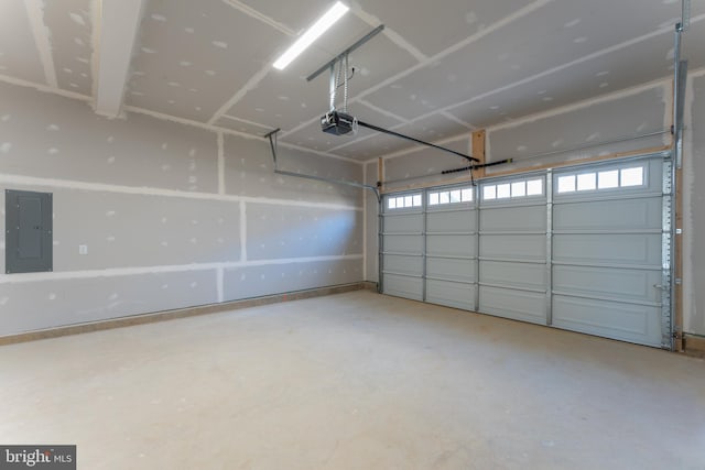 garage with a garage door opener and electric panel