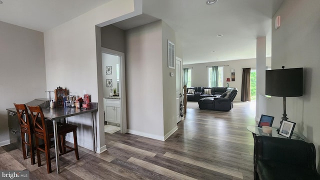interior space featuring baseboards, recessed lighting, and wood finished floors