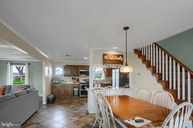 tiled dining area with stairs, a wealth of natural light, recessed lighting, and crown molding