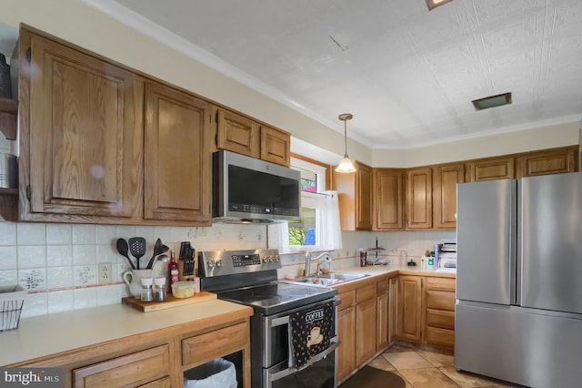 kitchen featuring a sink, tasteful backsplash, brown cabinets, light countertops, and appliances with stainless steel finishes