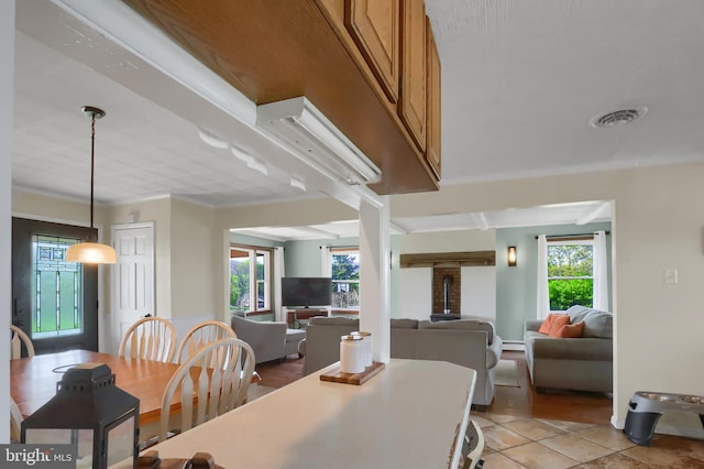 dining space with visible vents, a wealth of natural light, and light tile patterned floors