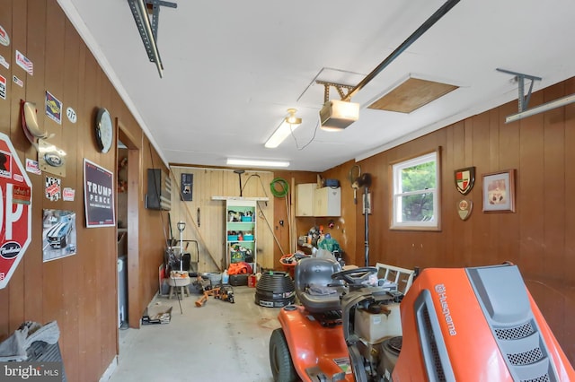 garage with wood walls and a garage door opener