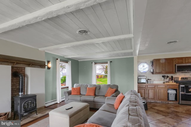 tiled living area featuring beamed ceiling, a baseboard radiator, a wealth of natural light, and visible vents