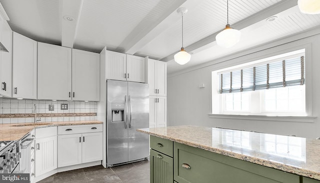 kitchen with stainless steel fridge, green cabinetry, backsplash, a sink, and white cabinetry
