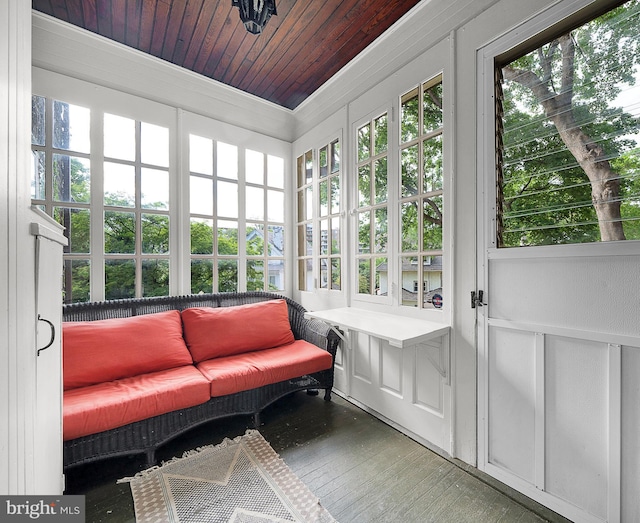 sunroom featuring french doors, crown molding, and wood finished floors