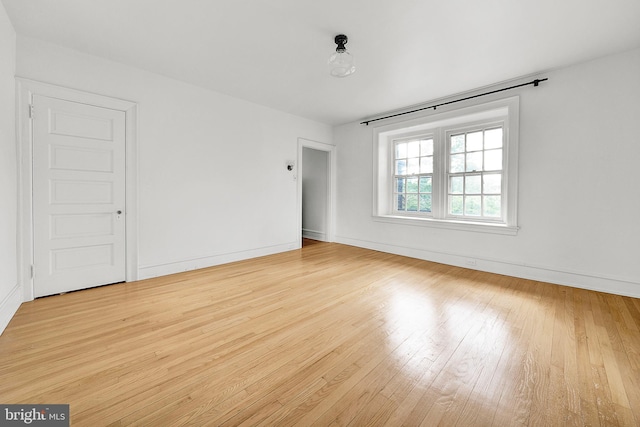 empty room with light wood-style floors and baseboards