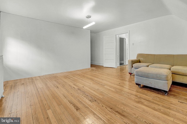 living area featuring hardwood / wood-style flooring and vaulted ceiling
