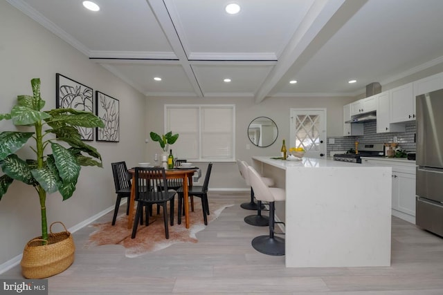 kitchen featuring recessed lighting, freestanding refrigerator, baseboards, and range