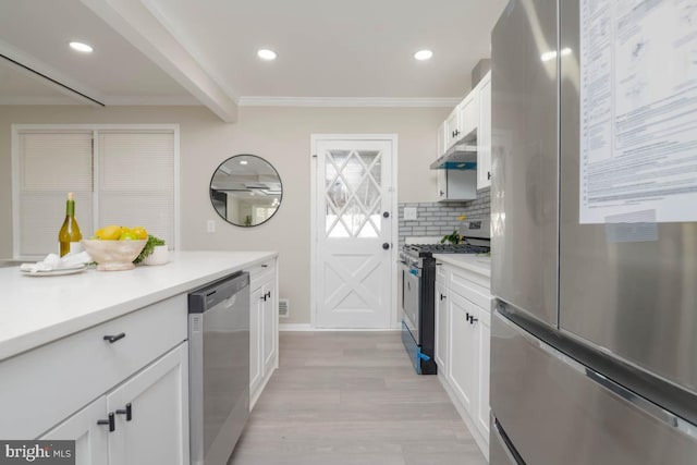 kitchen featuring under cabinet range hood, stainless steel appliances, light countertops, light wood-type flooring, and white cabinetry
