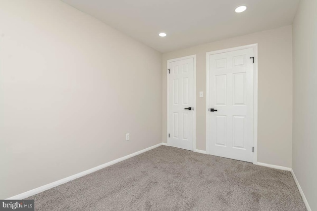 unfurnished bedroom featuring recessed lighting, carpet, and baseboards