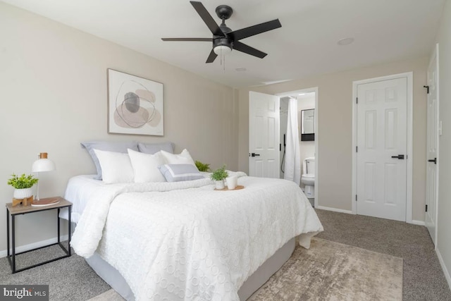 carpeted bedroom featuring ceiling fan, baseboards, and ensuite bathroom