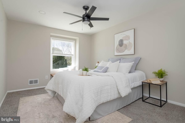 bedroom featuring baseboards, a ceiling fan, visible vents, and carpet floors