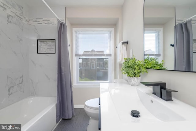 full bathroom featuring toilet, vanity, and shower / tub combo with curtain