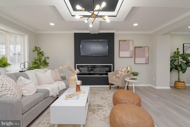 living room with recessed lighting, ornamental molding, light wood-type flooring, baseboards, and a chandelier