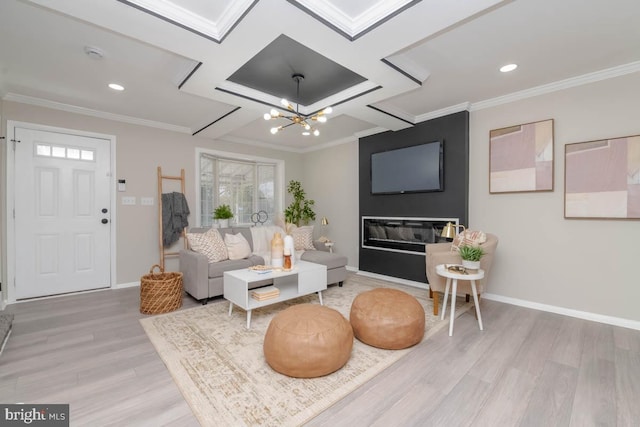 living room featuring baseboards, ornamental molding, light wood-style floors, and an inviting chandelier