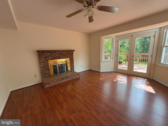 unfurnished living room with plenty of natural light, wood finished floors, and french doors